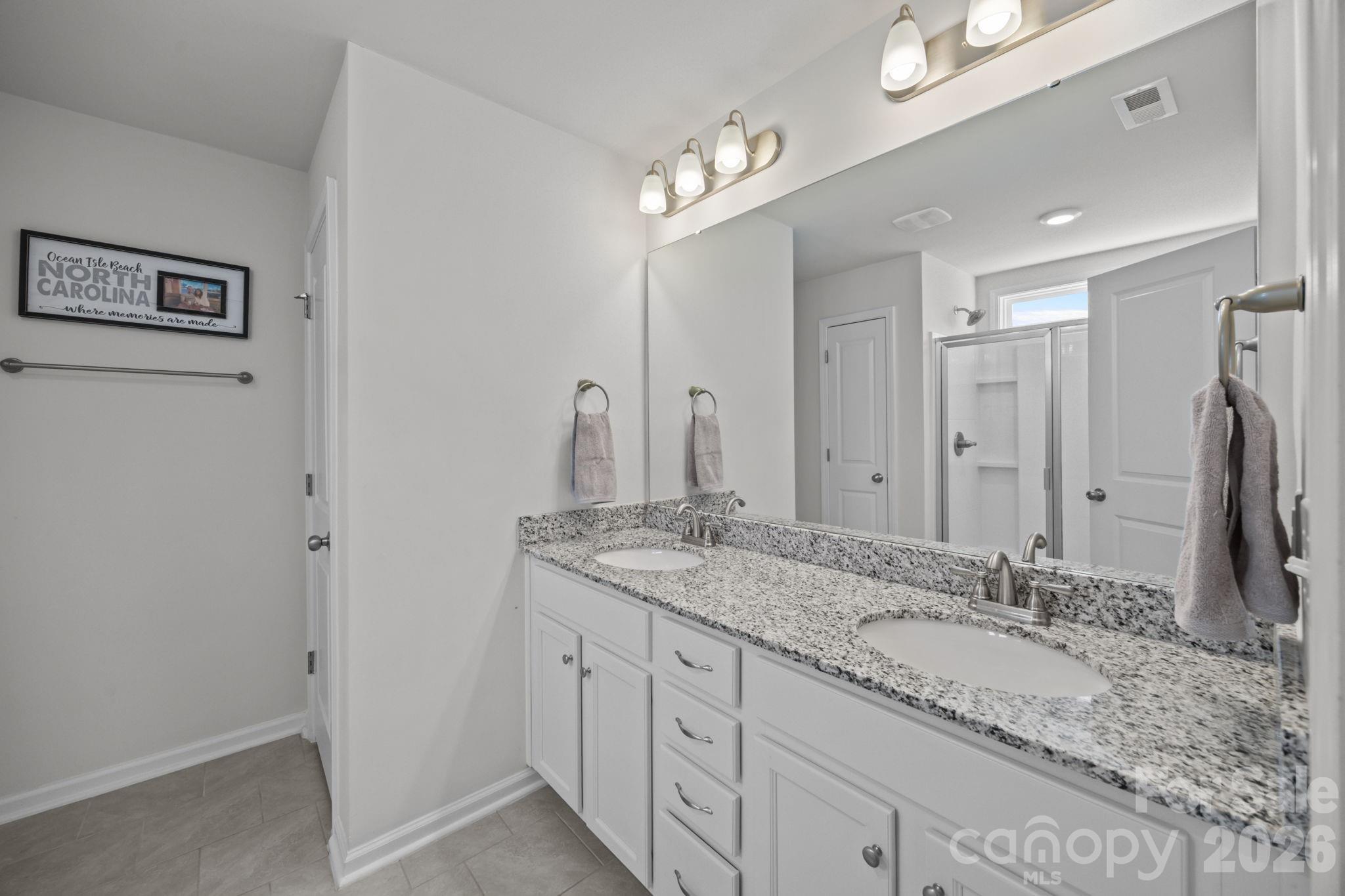 3808 Yorkshire Place Terrell, NC 28682 - Photo 23 of 36 a bathroom with a granite countertop double vanity sink and a mirror