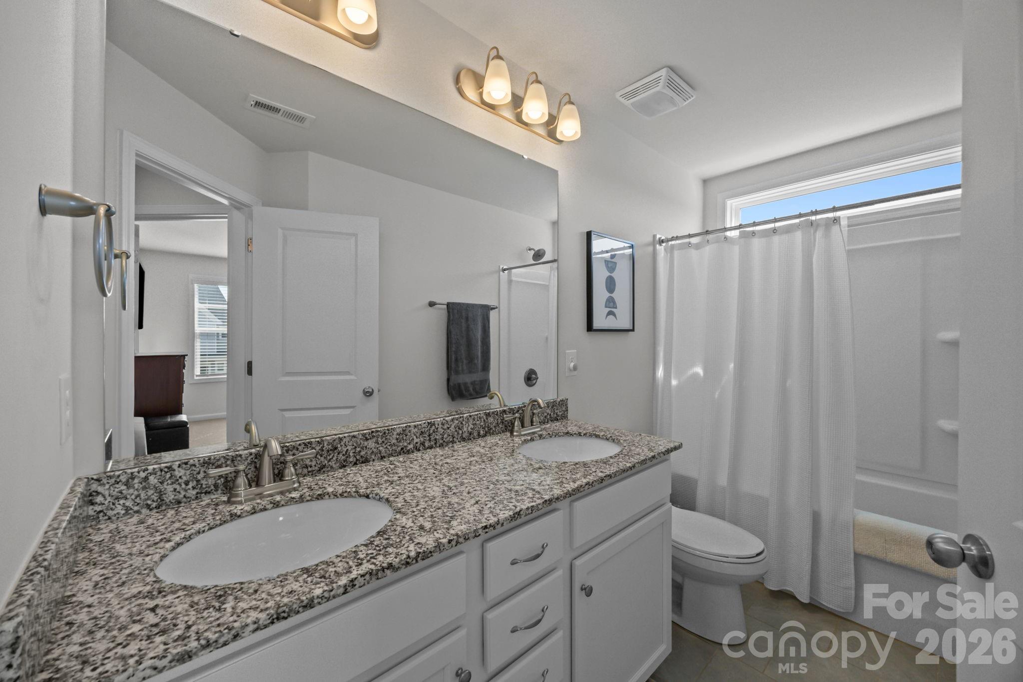 3808 Yorkshire Place Terrell, NC 28682 - Photo 27 of 36 a bathroom with a granite countertop sink toilet and shower