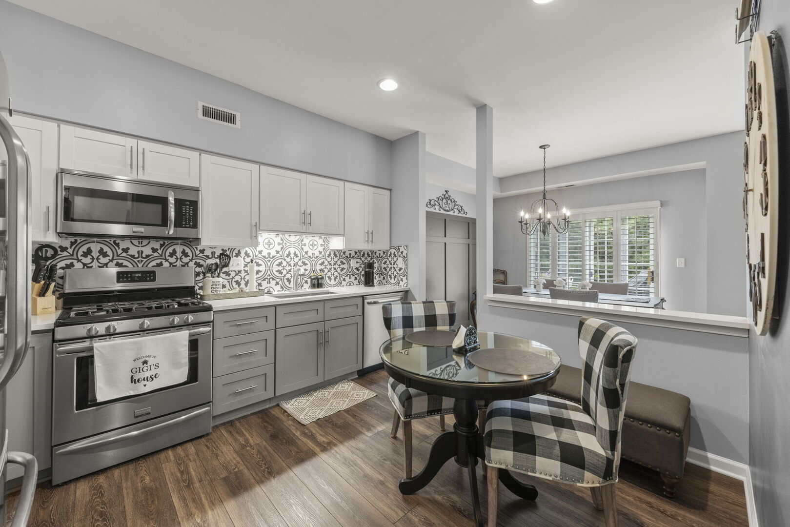 2406 Georgetown Circle Aurora, IL 60503 - Photo 11 of 28 a kitchen with kitchen island granite countertop a stove a sink a dining table and chairs