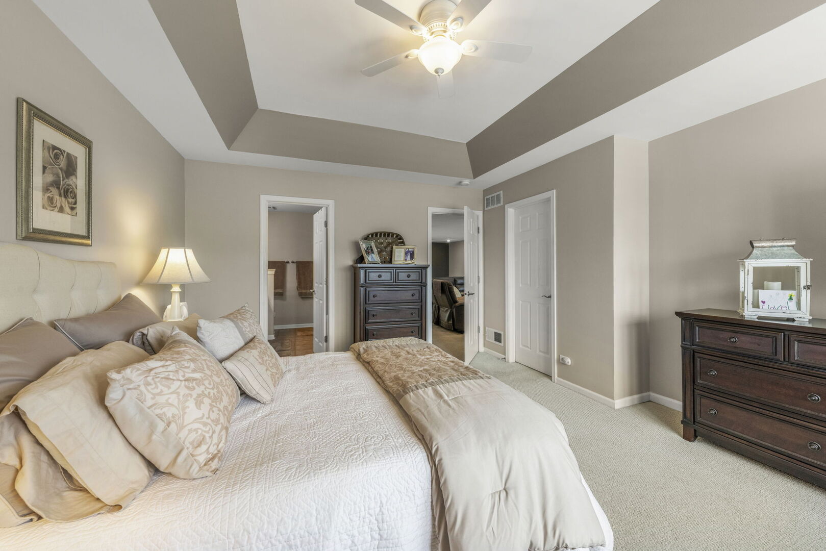 2406 Georgetown Circle Aurora, IL 60503 - Photo 19 of 28 a bedroom with a bed and a chandelier