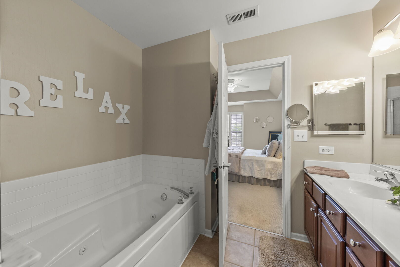 2406 Georgetown Circle Aurora, IL 60503 - Photo 21 of 28 a en suite spacious bathroom with a tub double vanity and mirror