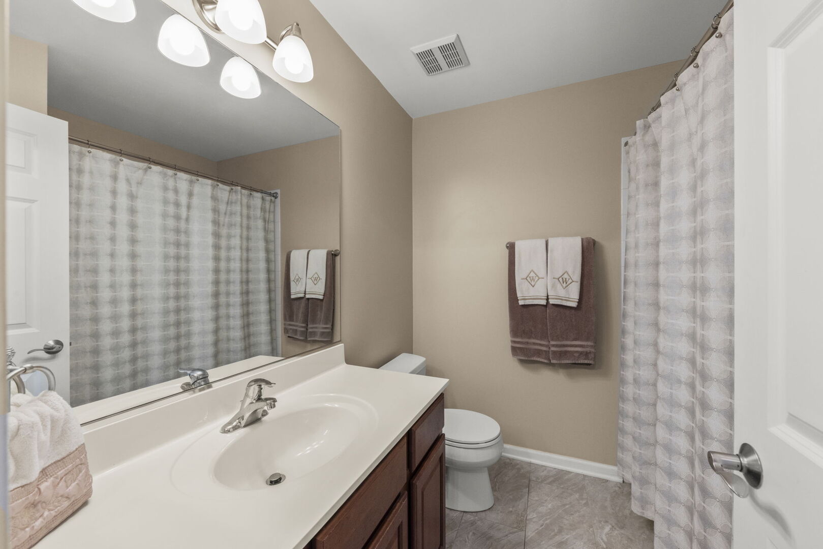 2406 Georgetown Circle Aurora, IL 60503 - Photo 25 of 28 a bathroom with a sink vanity mirror and toilet