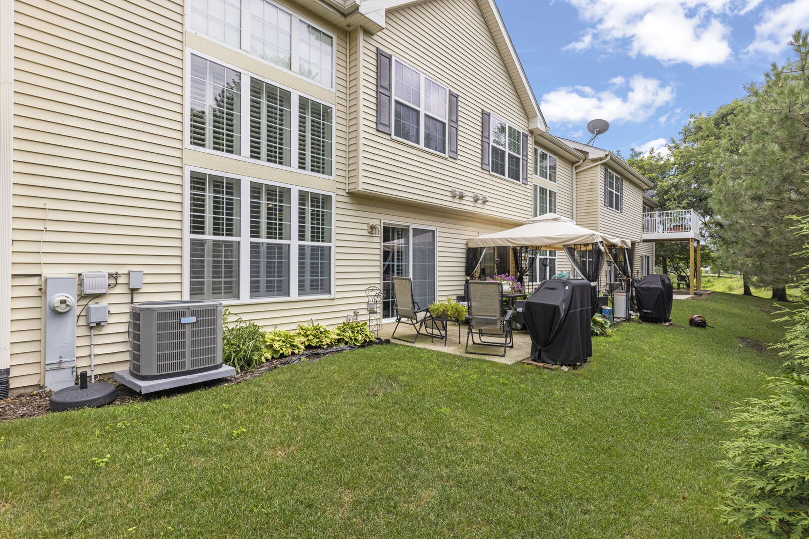 2406 Georgetown Circle Aurora, IL 60503 - Photo 28 of 28 a front view of a building with garden and sitting area