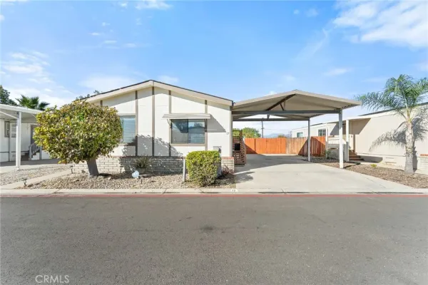a view of a house with a patio and a yard