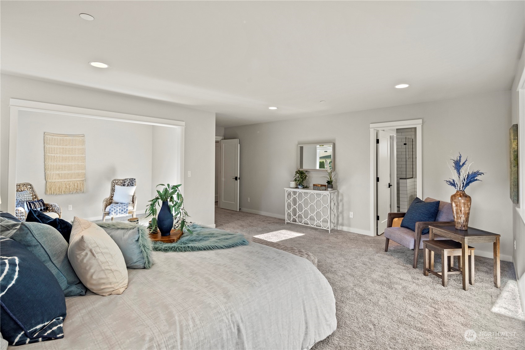 8711 240th Street Southwest Edmonds, WA 98026 - Photo 24 of 37 a spacious bedroom with a bed a table and chair