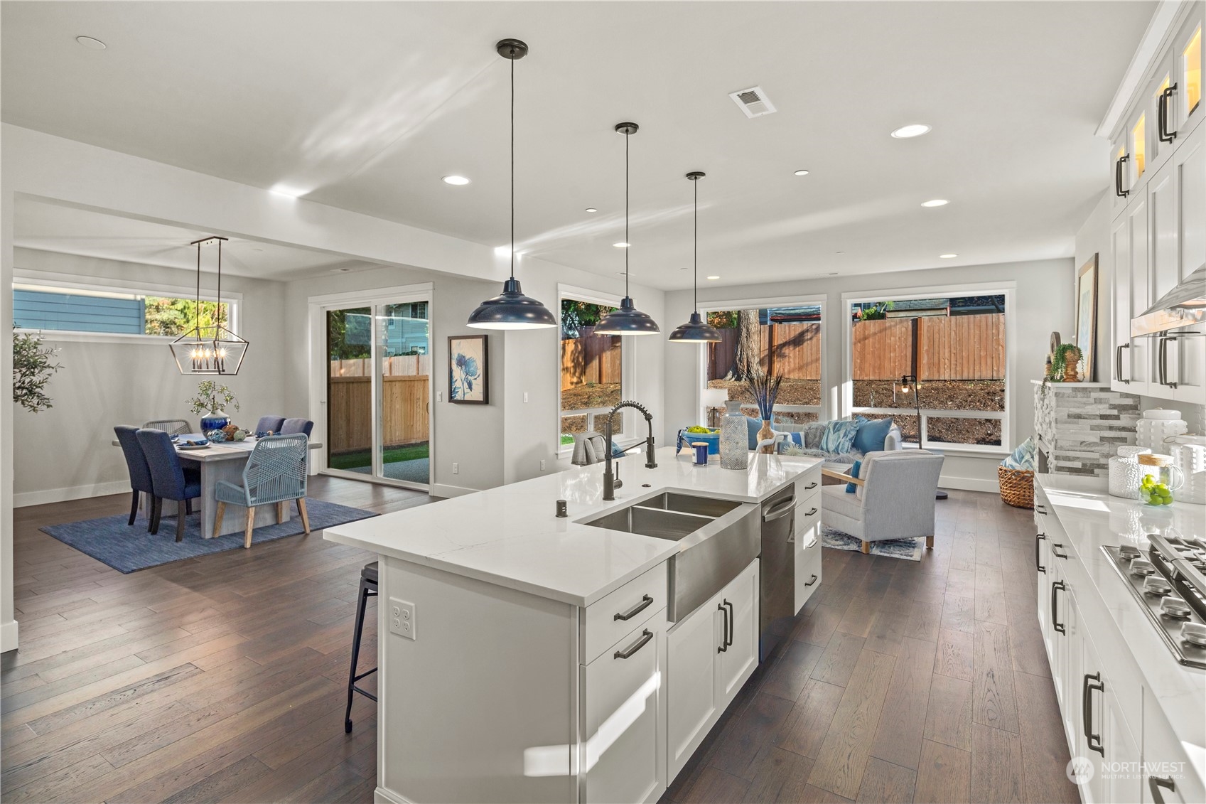 8711 240th Street Southwest Edmonds, WA 98026 - Photo 8 of 37 a kitchen with stainless steel appliances a stove a sink a oven a dining table and chairs
