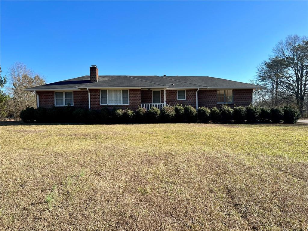 a front view of house with yard and trees