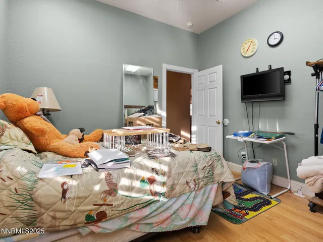 a bedroom with a bed and a flat screen tv