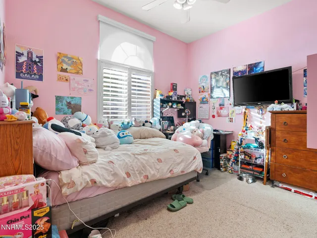 a living room filled with furniture and a flat screen tv