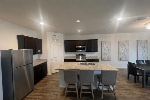 a kitchen with a dining table and chairs