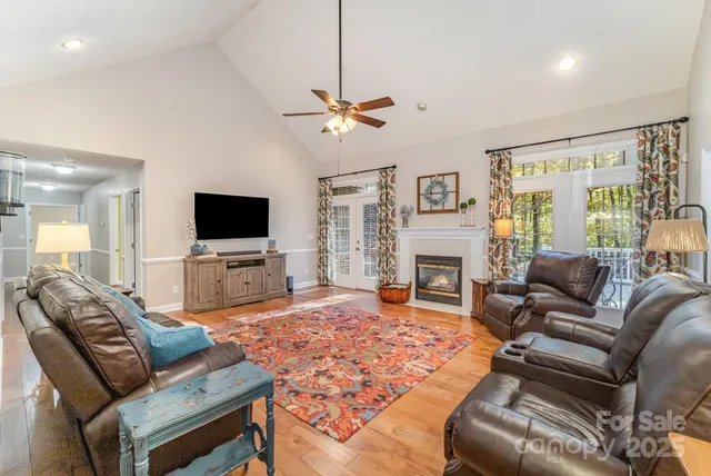 a living room with furniture flat screen tv and a fireplace