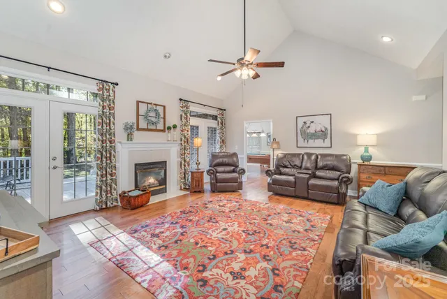 a living room with furniture a fireplace and a flat screen tv
