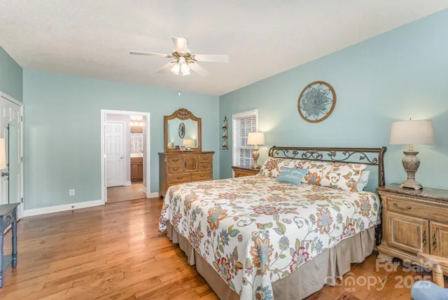 a bedroom with a large bed and a chandelier