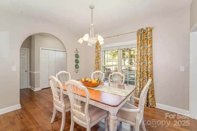a view of a dining room with furniture and chandelier