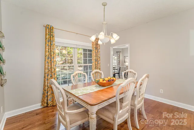 a view of a dining room with furniture wooden floor and chandelier