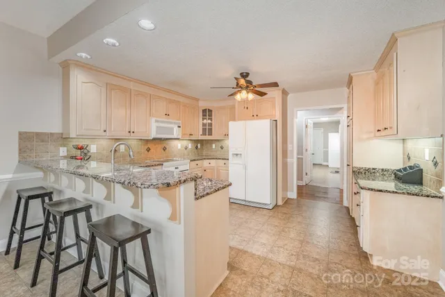 a kitchen with refrigerator and cabinets