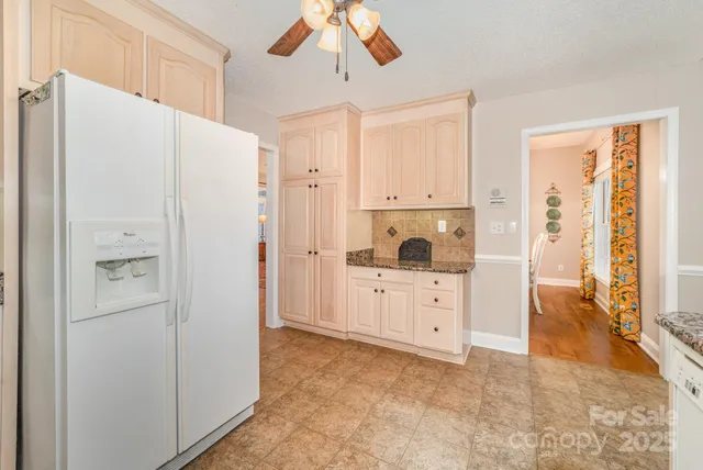 a kitchen with white cabinets and white appliances
