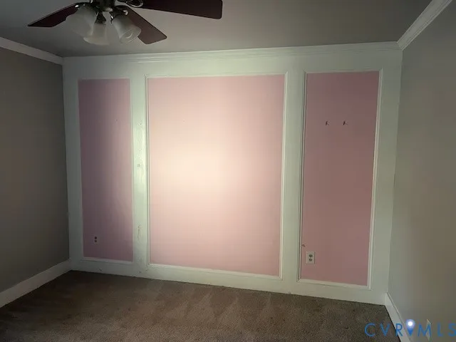 an empty room with a ceiling fan and carpet