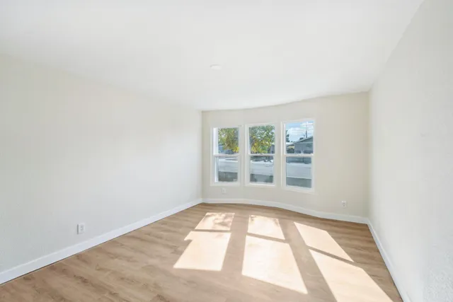 a view of an empty room and wooden floor