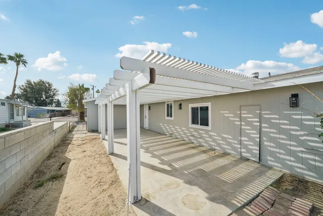 a aerial view of a house with large windows and couches