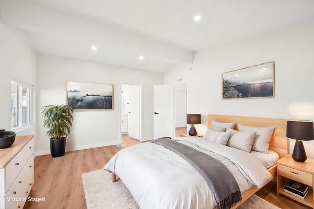 a bedroom with a large bed and a couch