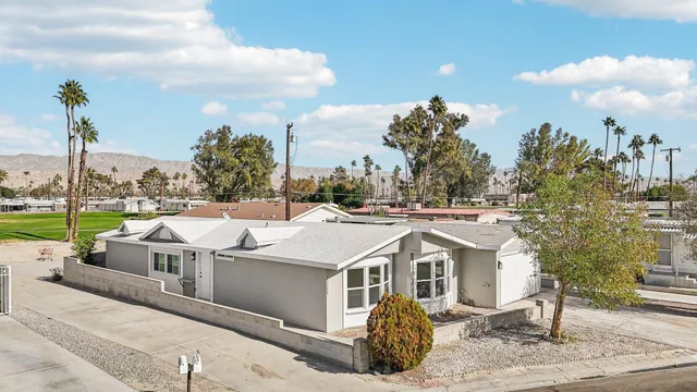 a view of a patio with table and chairs potted plants