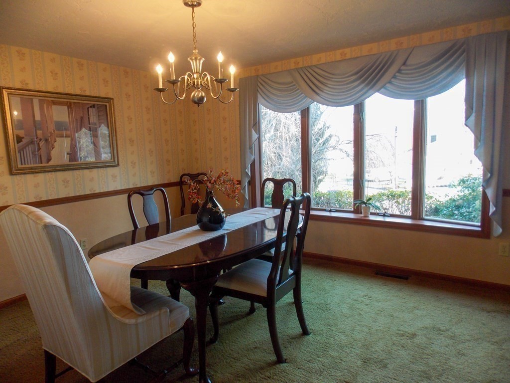 22 Lantern Lane Worcester, MA 01609 - Photo 12 of 32 a view of a dining room with furniture a chandelier and window