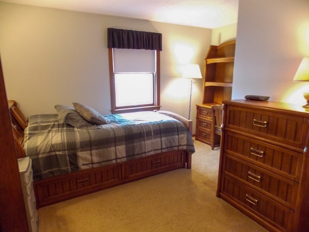 22 Lantern Lane Worcester, MA 01609 - Photo 27 of 32 a bedroom with a bed and a cabinets