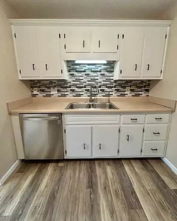 a view white cabinets with wooden floor