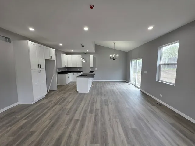 a view of kitchen with wooden floor and electronic appliances