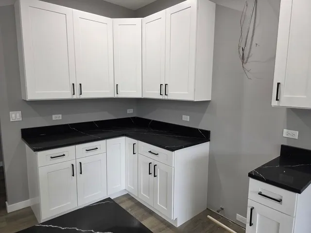 a kitchen with white cabinets and white appliances