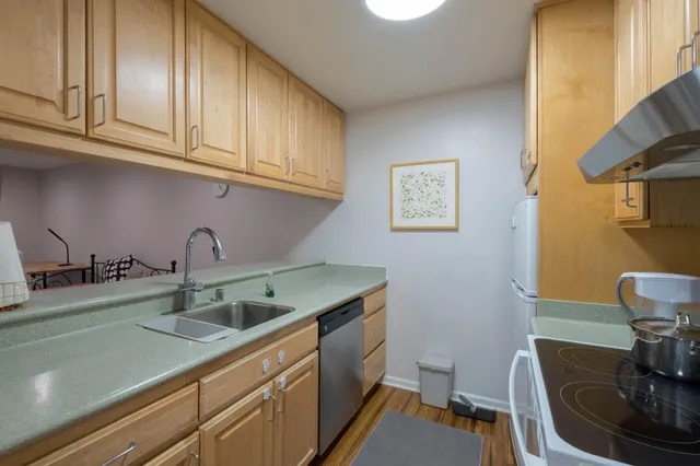 a kitchen with stainless steel appliances granite countertop a sink and cabinets