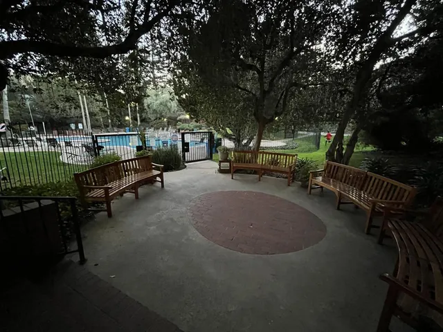 a view of backyard with deck and outdoor seating