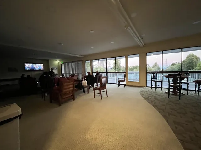 a living room with furniture large window and flat screen tv