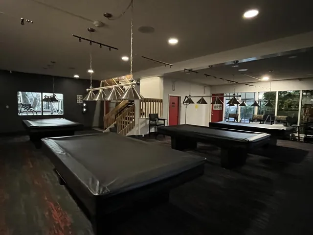a living room with furniture a table and potted plants