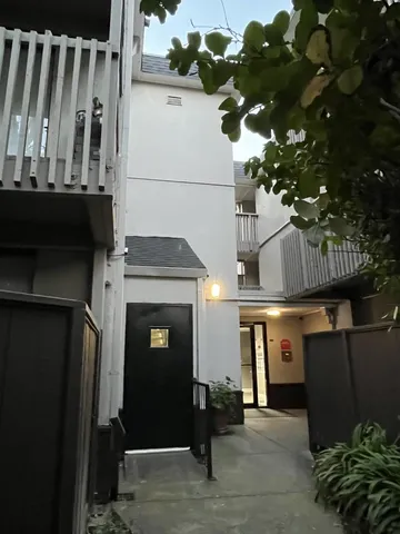 a utility room with dryer washer and a view of living room