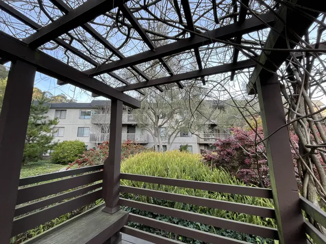a view of backyard of house with green space