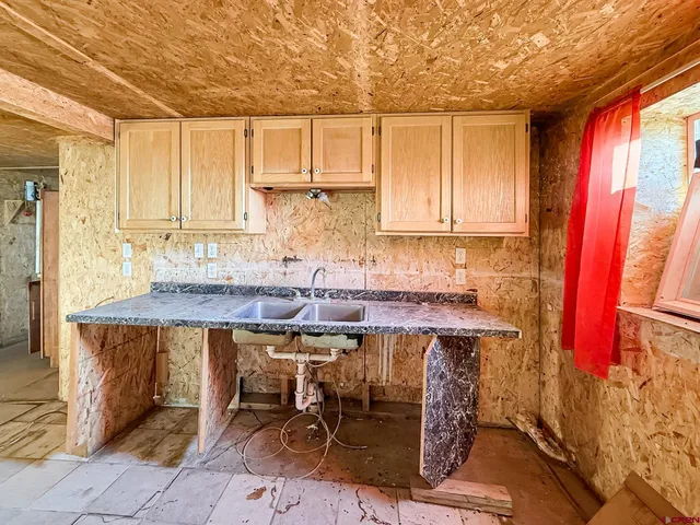 a view of a room with wooden floor and windows