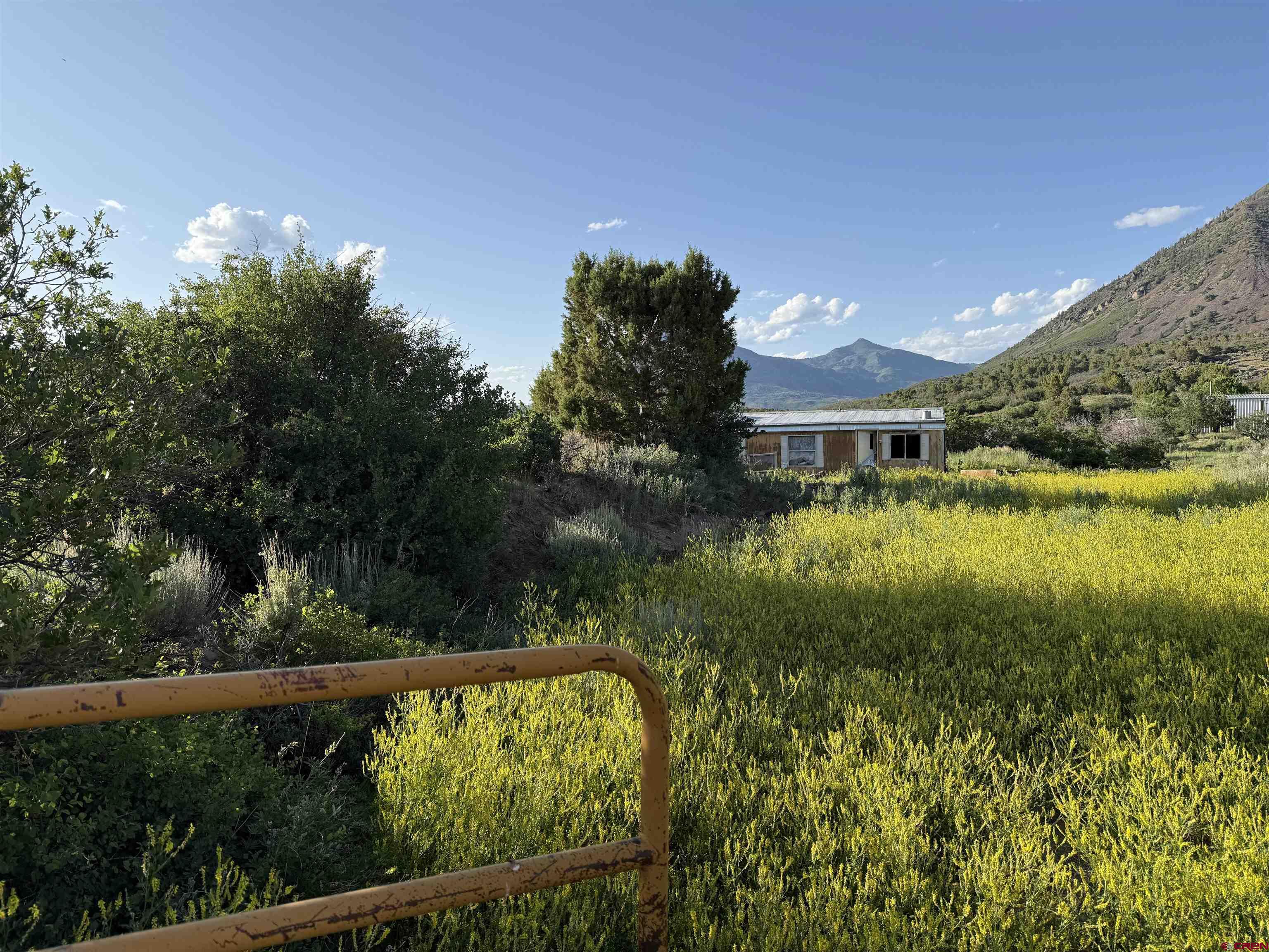 43867 Long Gulch Road Crawford, CO 81415 - Photo 33 of 45 a view of a lake with a house in the background