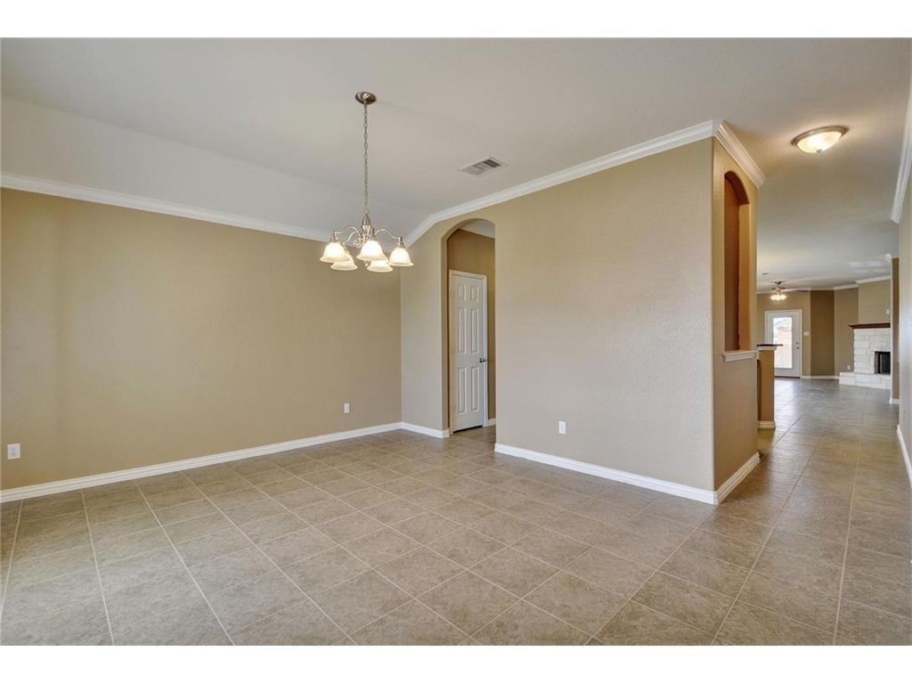 2109 Granite Springs Road Leander, TX 78641 - Photo 10 of 30 A versatile open-plan area offers ample space for formal dining or a flexible living arrangement.