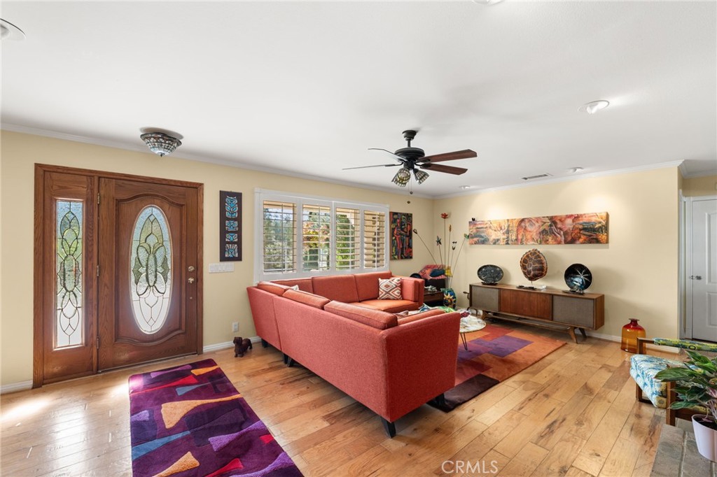 16620 Rocky Glen Road Perris, CA 92570 - Photo 12 of 72 a living room with furniture ceiling fan and a large window