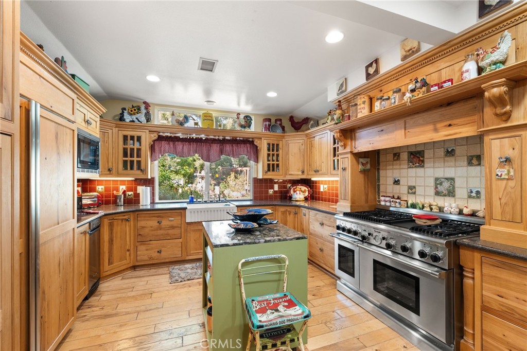 16620 Rocky Glen Road Perris, CA 92570 - Photo 17 of 72 a kitchen with stainless steel appliances granite countertop a stove a sink and a refrigerator