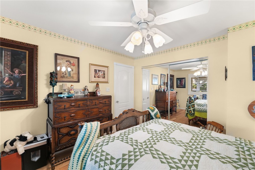 16620 Rocky Glen Road Perris, CA 92570 - Photo 26 of 72 a bed room with a bed and a chandelier