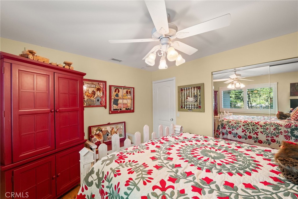 16620 Rocky Glen Road Perris, CA 92570 - Photo 29 of 72 a bedroom with a large bed and a chandelier