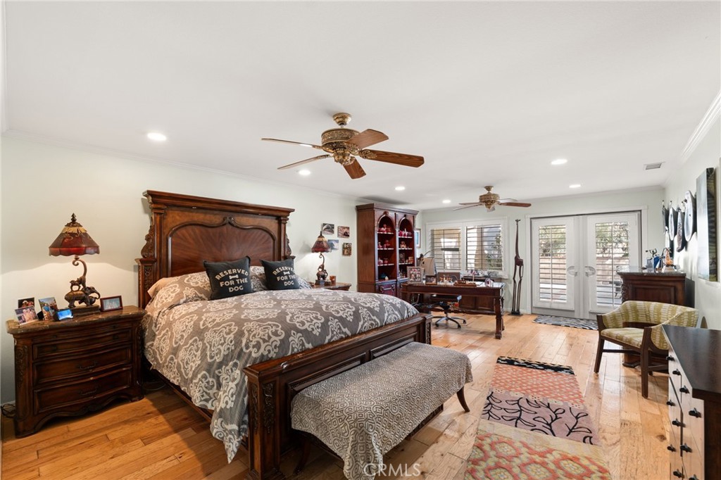16620 Rocky Glen Road Perris, CA 92570 - Photo 30 of 72 a bedroom with a bed and wooden floor