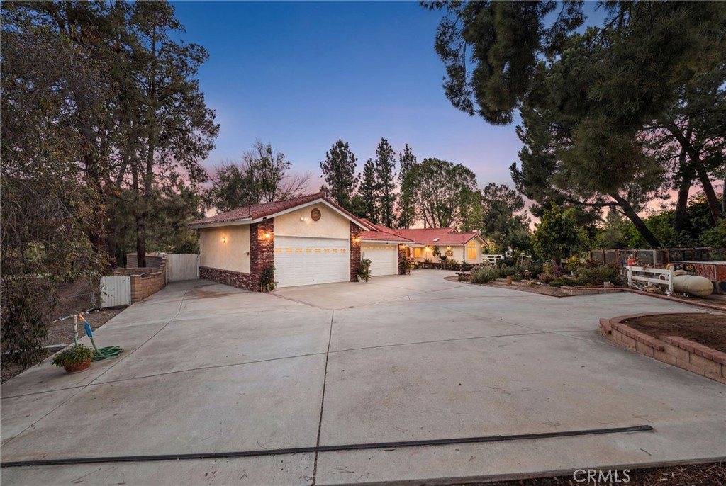 16620 Rocky Glen Road Perris, CA 92570 - Photo 3 of 72 a front view of a house with a yard and garage
