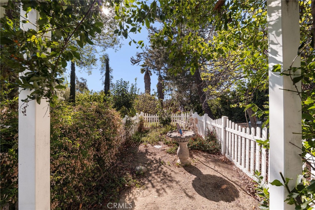 16620 Rocky Glen Road Perris, CA 92570 - Photo 40 of 72 a view of a house with a small yard and large trees