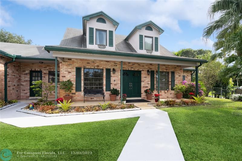 2800 Southwest 154th Lane Davie, FL 33331 - Photo 1 of 30 a front view of a house with sitting area and garden