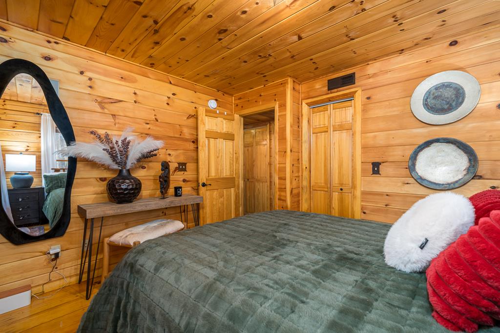 229 Ringtail Run Murphy, NC 28906 - Photo 21 of 68 a bedroom with a bed and a chandelier