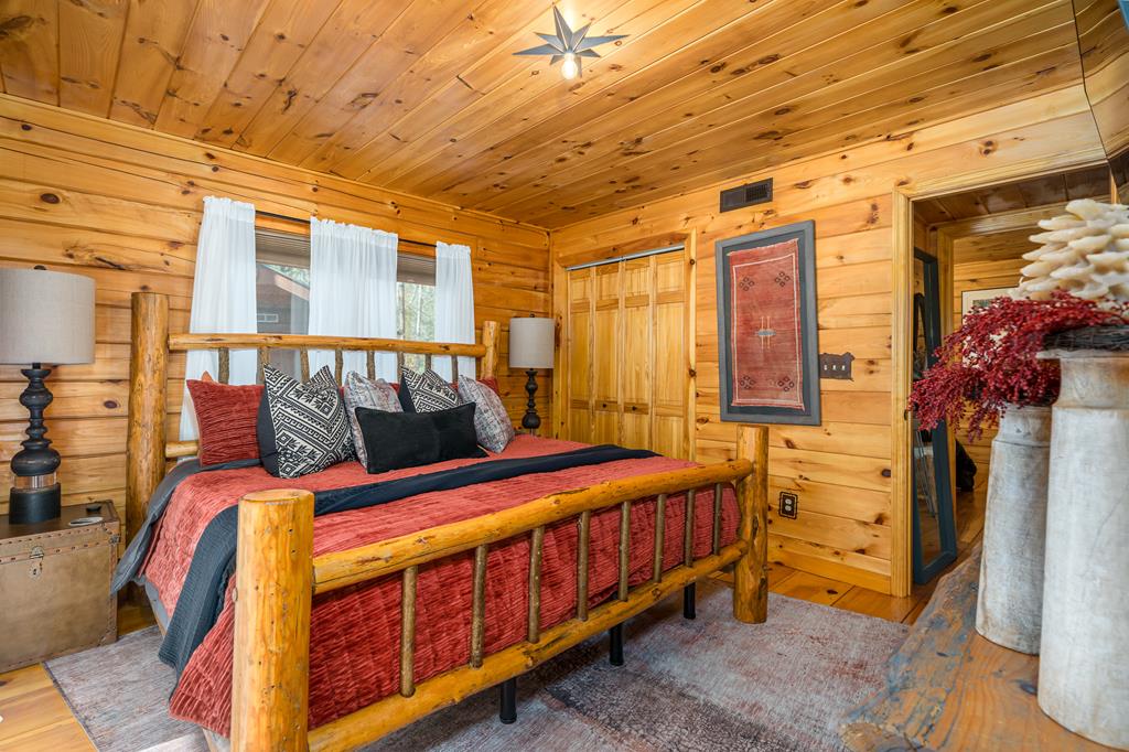 229 Ringtail Run Murphy, NC 28906 - Photo 25 of 68 a bedroom with a bed and a chandelier